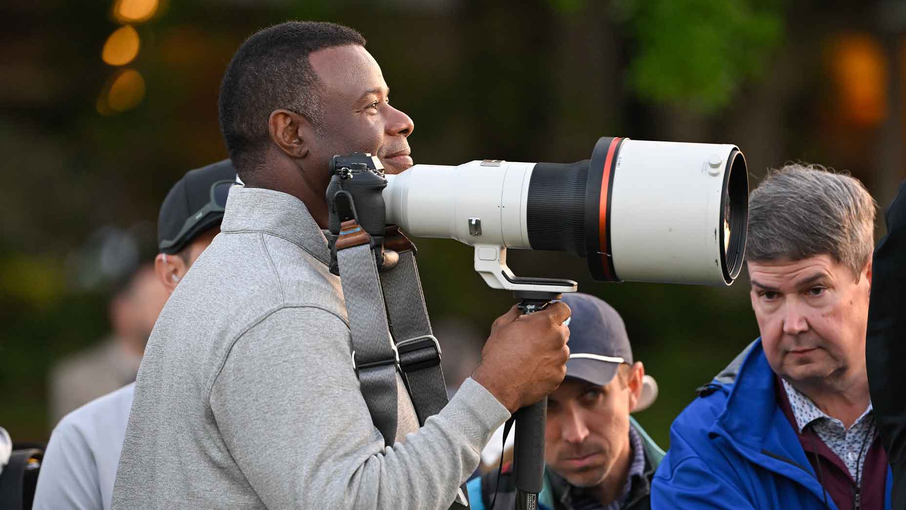 Ken Griffey Jr. holds camera lens in his hand at the Masters at Augusta National.
