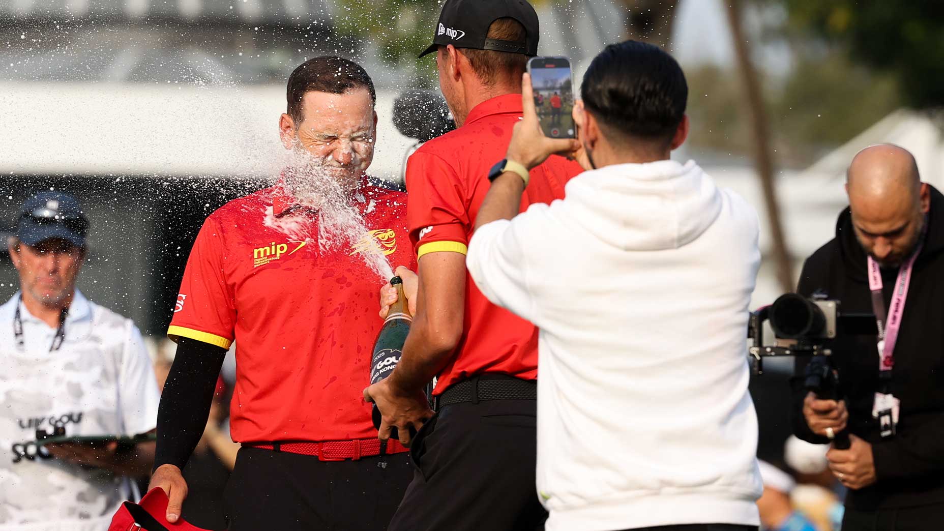 sergio garcia splashes champagne in the face of a competitor at LIV event