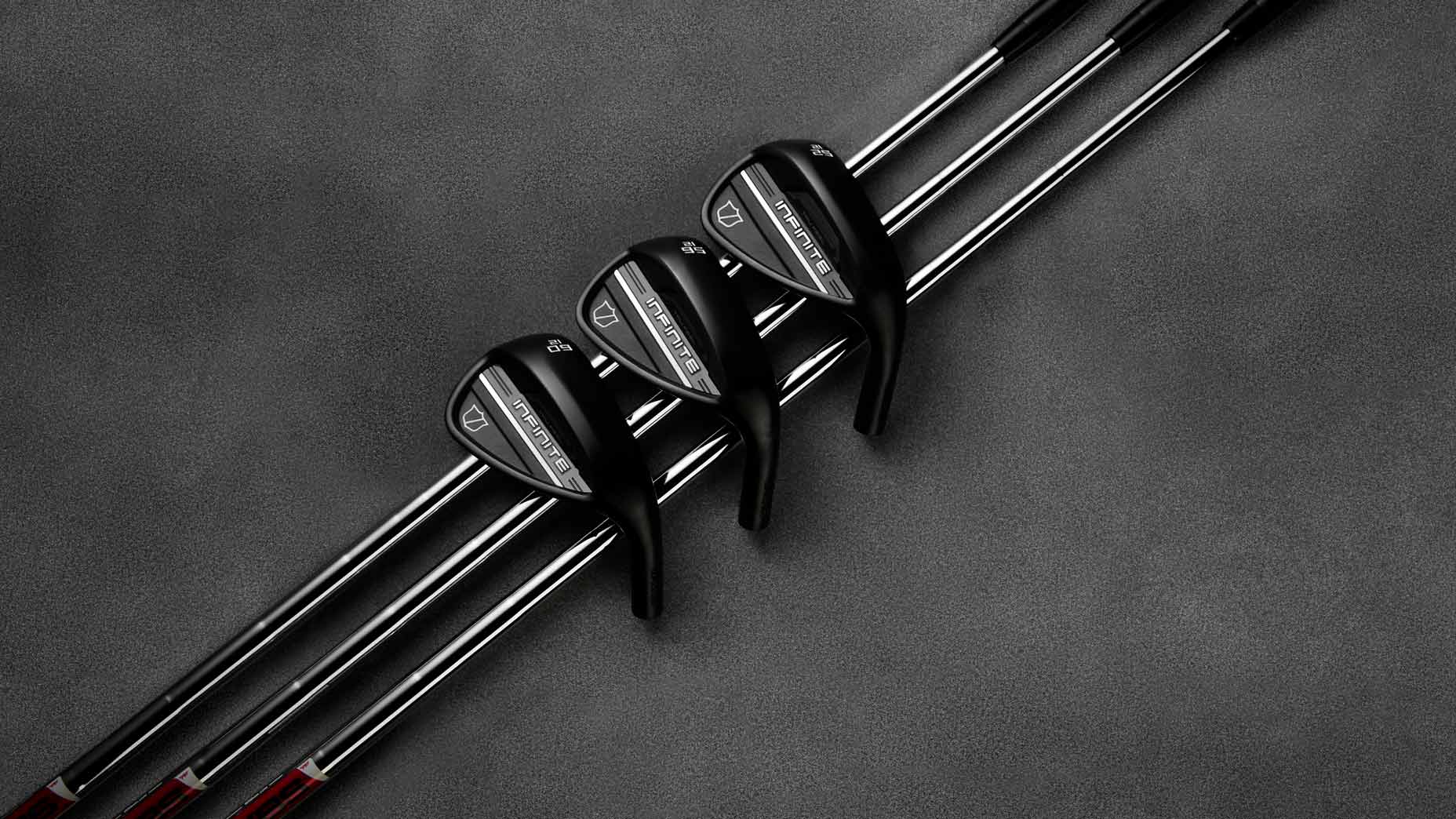 Wilson Golf Infinite Wedges aranged on grey background.