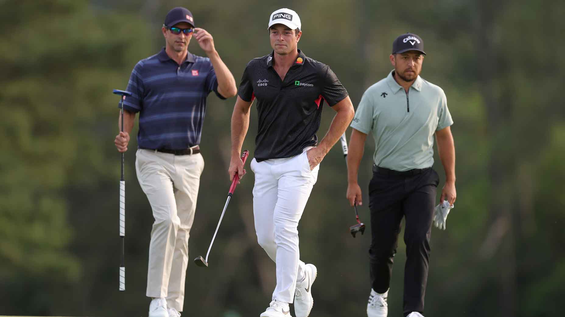 Masters players adam scott, viktor hovland and rory mcilroy stand alongside one another during round 1 of the 2025 masters